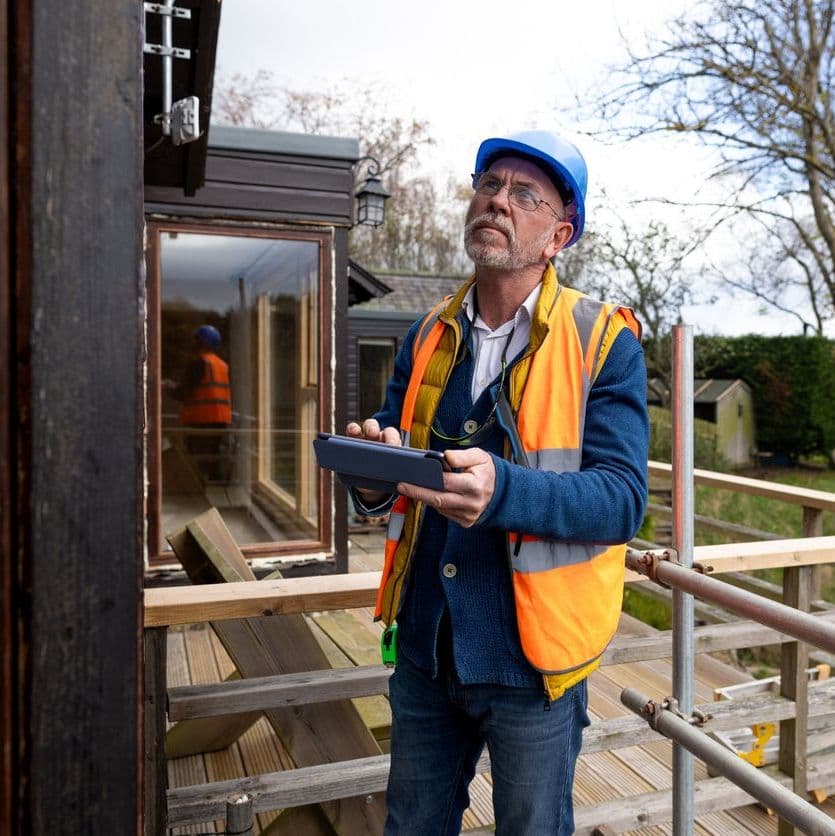 Field insurance adjuster inspecting home